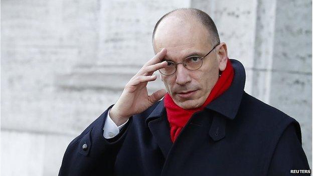 Italy's Prime Minister Enrico Letta gestures as he leaves his house in downtown Rome on 14 February