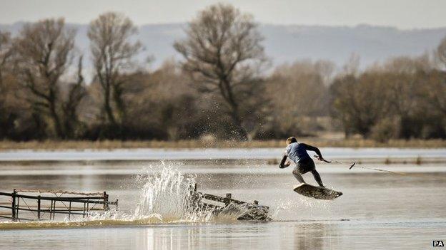 A wakeboarder rides the flood water on the Somerset Levels