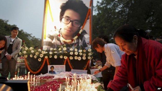 Supporters of Nido Tania, a 20-year-old university student, light candles at Jantar Mantar in New Delhi, India Saturday, Feb. 15, 2014