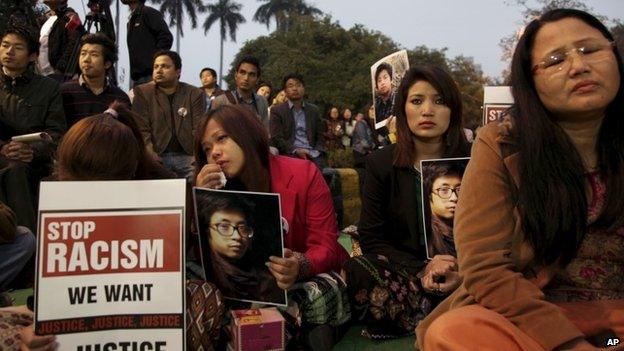 Supporters of Nido Tania, a 20-year-old university student, hold up his portrait as they gather to seek justice at Jantar Mantar in New Delhi, India Saturday, Feb. 15, 2014.