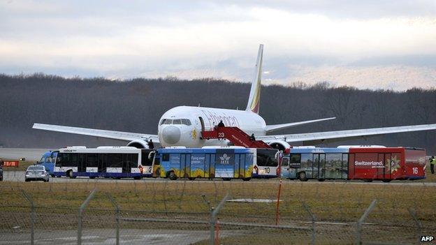 Police stand on an air stair leading the Ethiopian Airlines flight en route to Rome