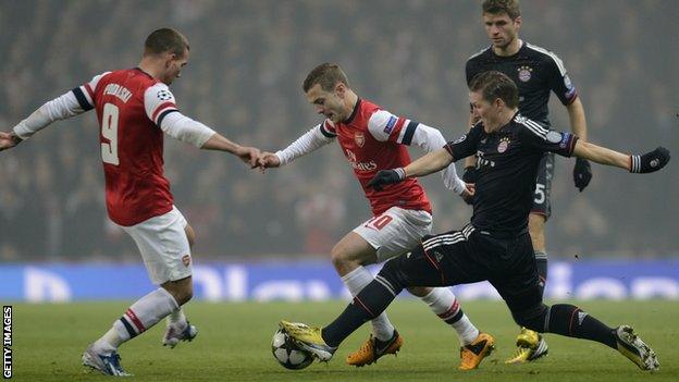 Bayern Munich midfielder Bastian Schweinsteiger (right) tackles Arsenal's midfielder Jack Wilshere (centre)