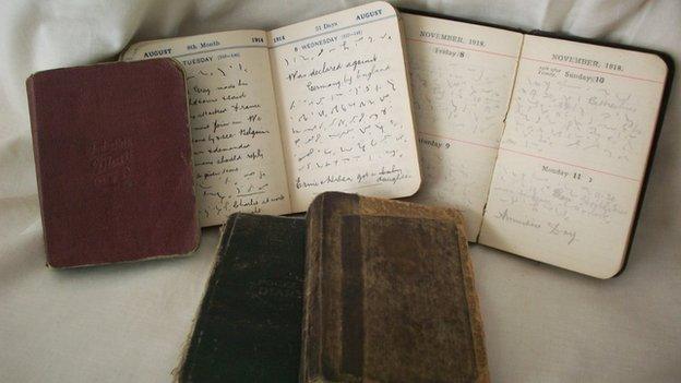 Diaries , and one of the five diaries, showing some open pages (in colour.)