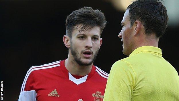 Mark Clattenburg (right) talks to Southampton's Adam Lallana