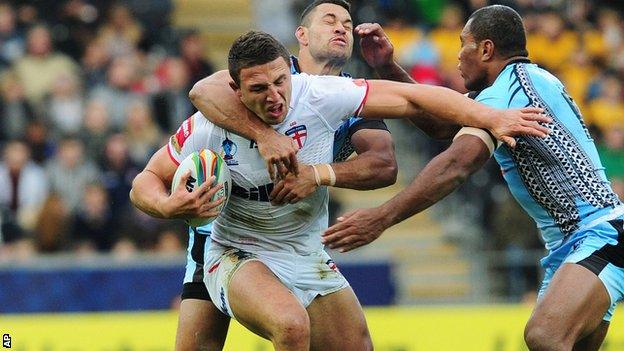 Sam Burgess (centre) is tackled by Fiji's Daryl Millard and Petro Civoniceva