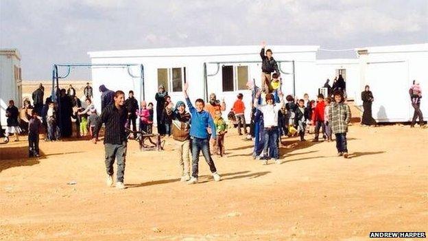 Smiling Syrian refugee children just inside the Jordanian border