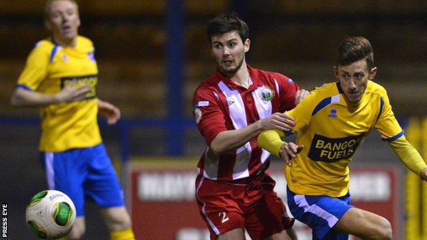 Warrenpoint defender Darren King in action against Bangor's Jordan Forsythe