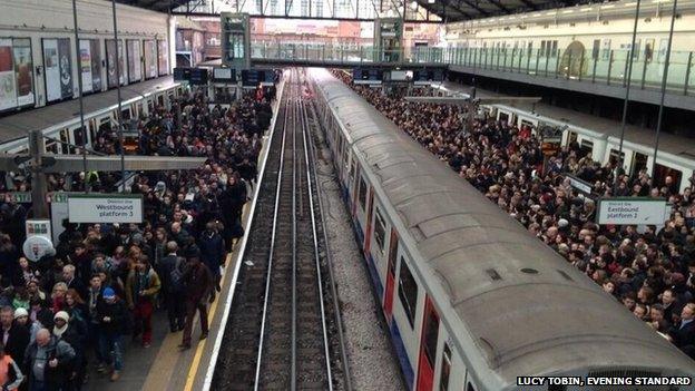 Hundreds of commuters queue for the tube at Earl's Court