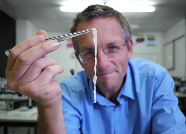 Michael Mosley holds up a human tapeworm