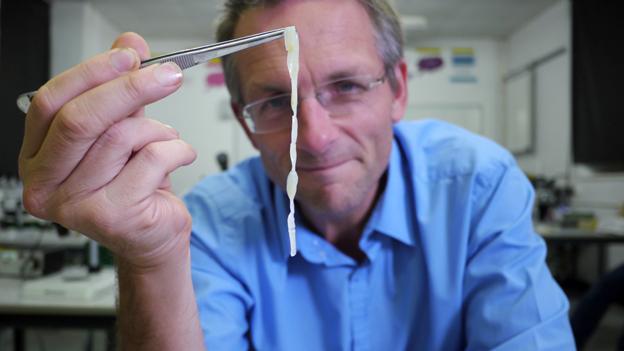 Michael Mosley holds up a human tapeworm