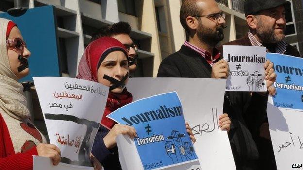 Activists and journalists take part in a demonstration in support of the al-Jazeera staff, who have been detained by Egyptian authorities since last year, in the Lebanese capital Beirut on 8 February 2014