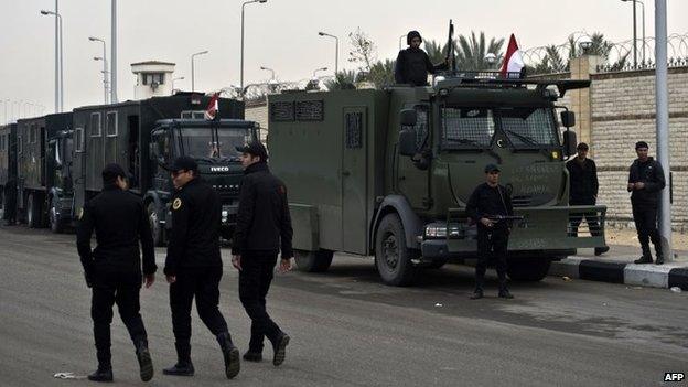 Egyptian riot police are deployed outside the Police Academy where a hearing in the espionage trial of Egypt's ousted Islamist president Mohamed Morsi is to be held in Cairo (16 February 2014)