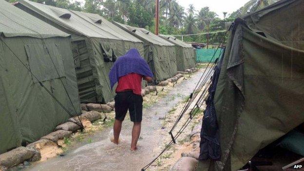 File photo: A man walks between tents at Australia's regional processing centre on Manus Island in Papua New Guinea