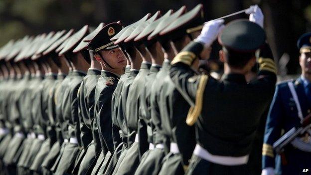 Chinese People's Liberation Army soldiers and officers line up in preparation to welcome visiting Indian Prime Minister Manmohan Singh in Beijing on 23 October 2013