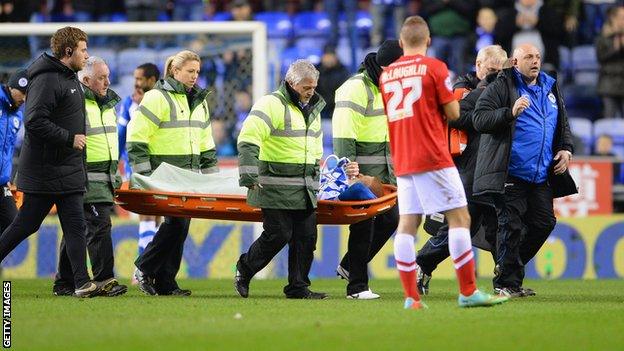 Wigan midfielder Ben Watson is stretchered off against Barnsley