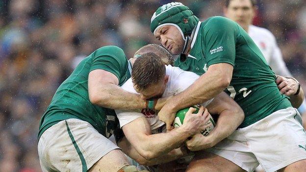 Rory Best (right) and Jamie Heaslip tackle Chris Ashton in last year's Six Nations clash