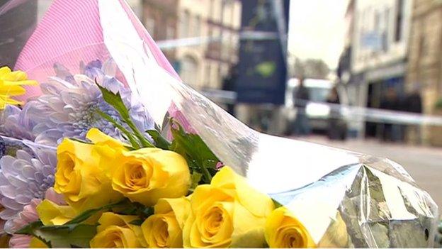 Floral tributes outside Fringe Benefits and La Bella Beauty in Southgate Street, Gloucester