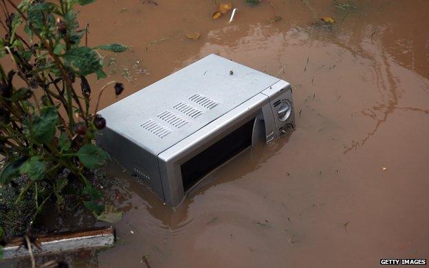 Microwave stands in floodwater