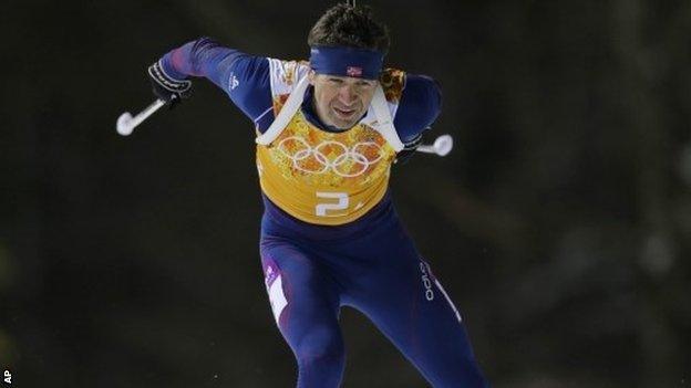 Norway's Ole Einar Bjoerndalen competes as his team win gold during the mixed biathlon relay at the 2014 Winter Olympics