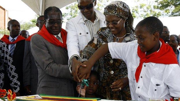 Left: Robert Mugabe and his wife and their two sons prepare to cut a birthday cake for Mr Mugabe's 85th birthday in 2009