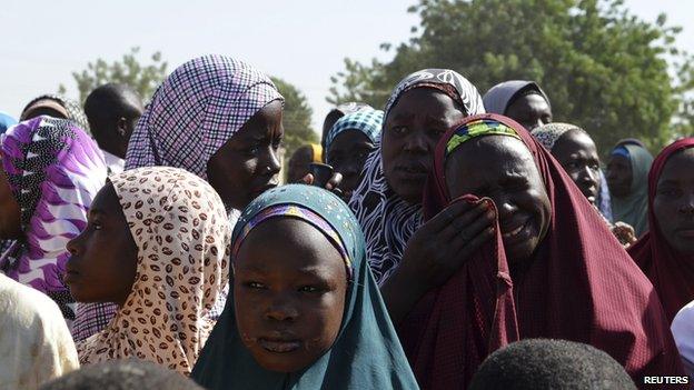A woman wipes away tears at a refugee camp for people displaced by violence in Borno state, Nigeria