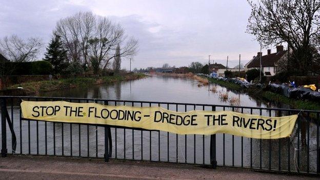 A protest banner on a bridge over the River Parrett in Burrowbridge calling for dredging to take place