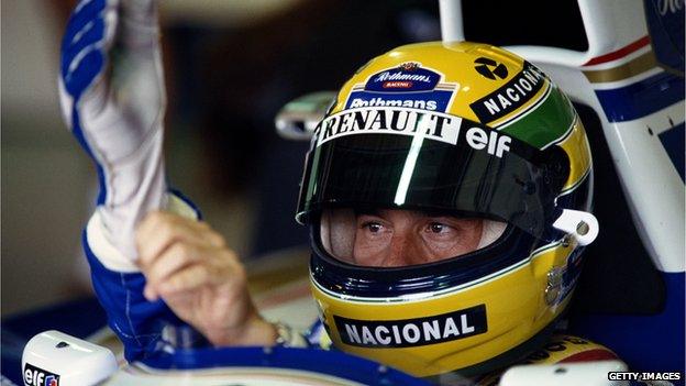 Ayrton Senna pulls on his gloves before he drives during practice for the Brazilian Grand Prix on 26th March 199