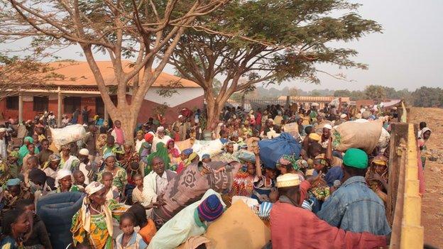 Muslims in a fenced courtyard waiting to join the AU convoy to take them to safety