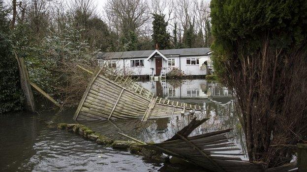 The fence of a flooded home near the river Thames