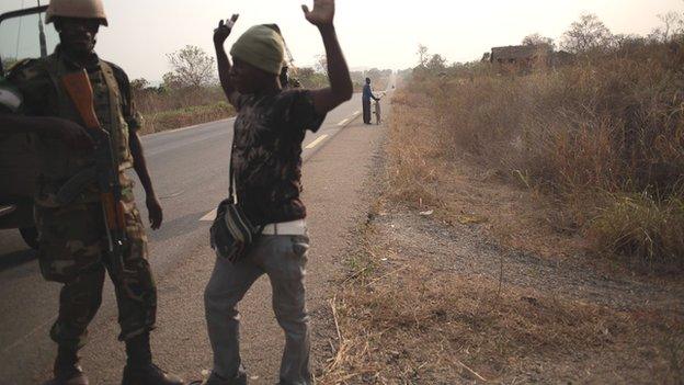 An AU peacekeeper disarming an anti-balaka militiamen