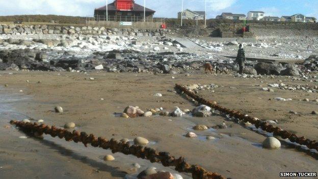 Chains uncovered on the beach at Rest Bay