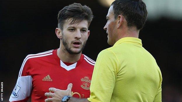 Referee Mark Clattenburg talks to Southampton's Adama Lallana during Everton's 2-1 win over the Saints