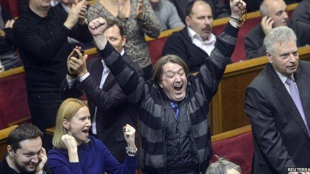 Ukraine's opposition members react during a Parliament session in Kiev