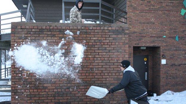 Sandy Boville and Khai Krepela preparing a wall ride in St Paul, Minnesota