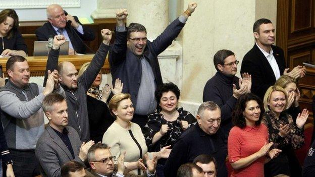 Opposition memebers, including leader Vitaly Klitschko (top R) celebrate as parliament votes to remove President Viktor Yanukovych