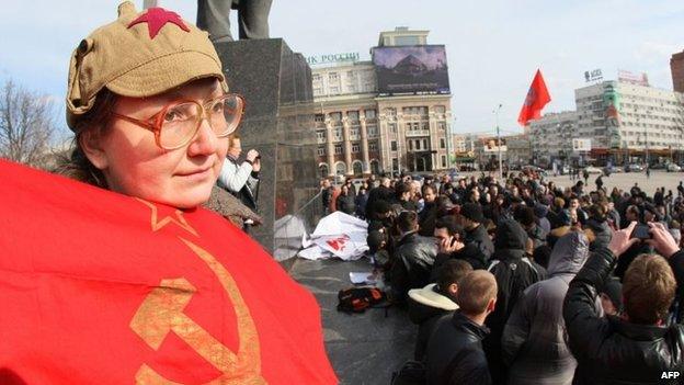 A woman holds a USSR flag during a rally of a newly organized movement called Eastern Front in the eastern industrial city of Donetsk