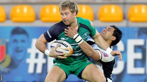 Fionn Carr is tackled by Dion Berryman in Italy