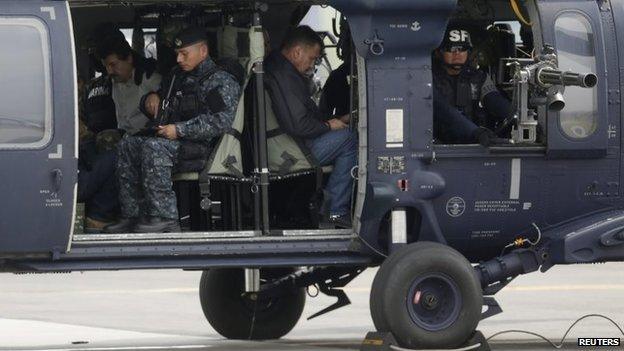 Joaquin "Shorty" Guzman (in white shirt) in a Mexican federal police helicopter in Mexico City on 22 February, 2014.