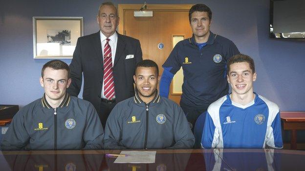 Back row: Roland Wycherley (Shrewsbury Town chairman), Mike Jackson (manager). Front row: Callum Burton, Dom Smith, Harry Lewis