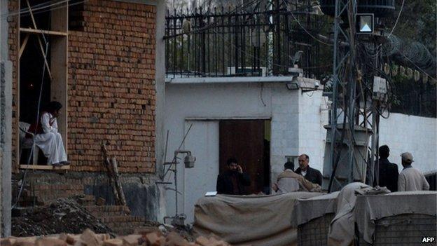 Pakistani security personnel gather outside the Iranian consulate following a suicide bomb attack in Peshawar on February on February 24, 2014.