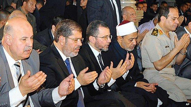 Abdul Fattah al-Sisi (far right) prays in Cairo, alongside President Mohammed Morsi (second-left)