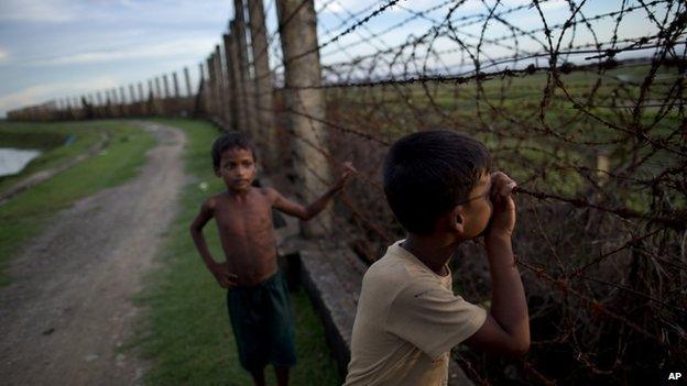 File photo: a Muslim boy looks through a barbed wire fence on the border of Myanmar and Bangladesh in Maungdaw, Rakhine state, Myanmar, 11 September 2013