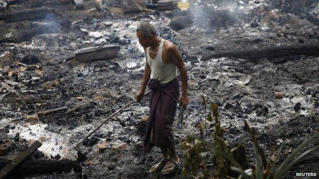 File photo: A Muslim man searches for his belongings left behind of his burnt home at Thapyuchai village, outside of Thandwe in the Rakhine state, following deadly Muslim-Buddhist clashes, 2 October 2013