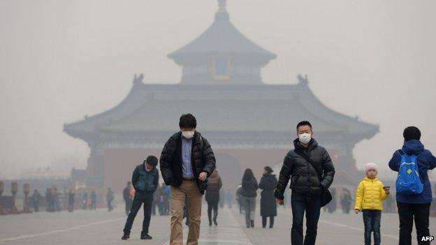 This picture taken on 24 February 2014 shows visitors wearing masks in Temple of Heaven in haze-covered Beijing