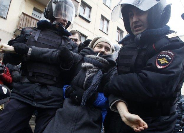 Police arrest a protester in Moscow, 24 February