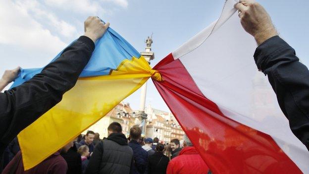 Polish and Ukraine flags tied together in Warsaw rally. 23 Feb 2014