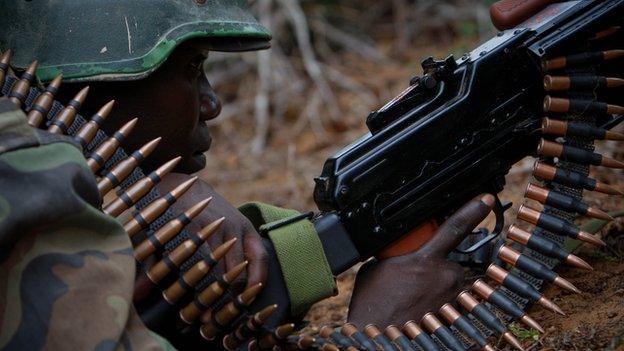 An African Union soldier takes cover during a battle in Somalia on 22 May 2012