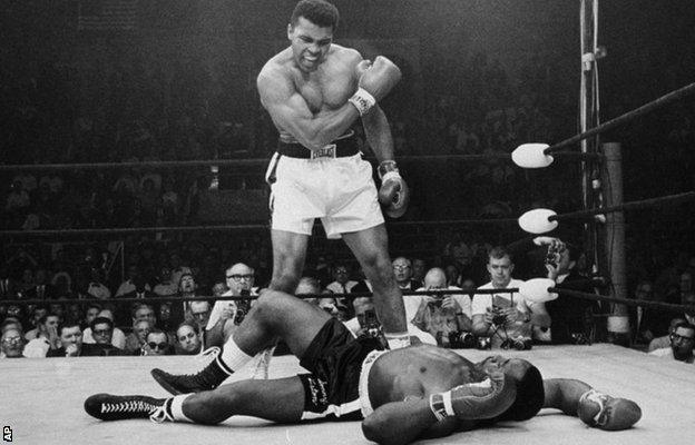 In this May 25, 1965 file photo, heavyweight boxing champion Muhammad Ali stands over fallen challenger Sonny Liston in Lewiston, Maine.