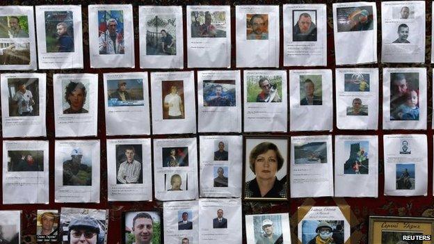 Photos of some of those killed in recent violence are seen at a makeshift memorial in Kiev's Independence Square