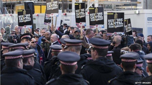 Police and protestors demonstrate outside the Old Bailey